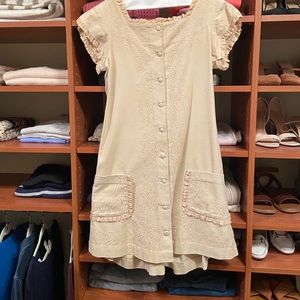 Vintage a-line cream dress with lace edges, pocket detail & subtle bustle.